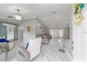 Open-concept living area with marble floors, stylish seating, and modern decor at 1109 Ne 22Nd Ave, Ocala, FL 34470