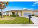 Inviting home with a well-manicured lawn, charming curb appeal, and a convenient two-car garage at 11799 Se 173Rd Lane Rd, Summerfield, FL 34491