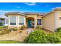 Charming single-story home featuring a colorful front door and neat landscaping at 11799 Se 173Rd Lane Rd, Summerfield, FL 34491