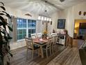 Inviting dining room with wood floors, modern lighting, and a large window at 14 Se 62Nd Ter, Ocala, FL 34471