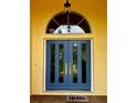 Stylish blue double front door with decorative glass and gold hardware at 14 Se 62Nd Ter, Ocala, FL 34471