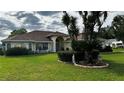 Charming yellow home with well-kept lawn and appealing landscaping details at 14 Se 62Nd Ter, Ocala, FL 34471