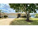 Well-maintained single Gathering home featuring a lush green lawn and mature landscaping at 15782 Sw 16Th Avenue Rd, Ocala, FL 34473