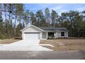 Charming single-story home featuring a two-car garage and a neatly landscaped front yard at 20 Malauka Pass Crse, Ocklawaha, FL 32179