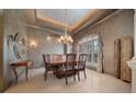 Formal dining area with elegant chandelier, decorative walls, and a large window with custom draperies at 2146 Se 25Th Loop, Ocala, FL 34471