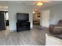 Open living room featuring tile floors and a view into the dining area at 21570 Sw Raintree St, Dunnellon, FL 34431