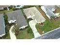 An aerial view showcasing the home's position in the neighborhood, including lawn, roof, and driveway at 2323 Nw 55Th Avenue Rd, Ocala, FL 34482