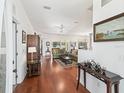 Inviting living room featuring hardwood floors, neutral walls, with an entryway and decorative accent tables at 2323 Nw 55Th Avenue Rd, Ocala, FL 34482