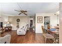 Cozy living room with rich flooring, comfortable seating, and a dining area with decorative table setting at 2433 Ne 7Th St # 3, Ocala, FL 34470