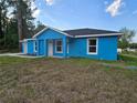 Lovely blue single-story home with a welcoming entrance and well-placed windows at 263 Oak Lane Trak, Ocala, FL 34472
