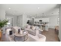 Open floorplan living room showcasing modern furnishings and flow into the kitchen area at 2647 Sw 178 St, Ocala, FL 34473
