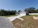 Inviting gray single-story home with an attached two-car garage and well-manicured front yard at 28 Olive Dr, Ocala, FL 34472