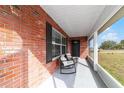Inviting screened front porch with rocking chairs, perfect for relaxing outdoors at 31 Palm Rd, Ocala, FL 34472