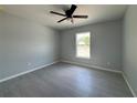 Comfortable bedroom with a ceiling fan, tile flooring, and a bright window at 4162 Sw Gardenia Ct, Dunnellon, FL 34431