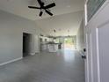 Open floor plan with tile flooring, a ceiling fan, and kitchen island at 4162 Sw Gardenia Ct, Dunnellon, FL 34431