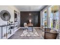Stylish home office with a modern desk, unique wall art, and ample natural light, creating an inspiring workspace at 4180 Sw 53Rd Lane Rd, Ocala, FL 34474