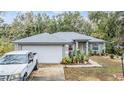 Charming single-story home with a well-maintained lawn, beautiful landscaping, and a gray roof at 42 Dogwood Drive Crse, Ocala, FL 34472