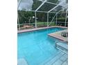 Inviting screened-in pool area with sparkling blue water and ample space for relaxation and outdoor enjoyment at 6512 Sw 60Th Ct, Ocala, FL 34474