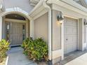 Close-up of the front door with decorative glass panels, next to the garage at 779 Oldsmar Ter, The Villages, FL 32163