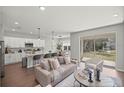 Open-concept living room, kitchen with island, stainless appliances and modern decor at 8272 Sw 139Th St, Ocala, FL 34473