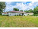 Charming home exterior with a well-manicured lawn, providing a welcoming curb appeal at 9 Fir Trail Pass, Ocala, FL 34472
