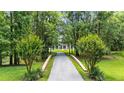 Long driveway leading to the home, surrounded by lush greenery and mature trees at 950 Sw 43Rd Pl, Ocala, FL 34471
