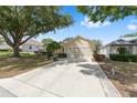 Charming single-story home with an extended concrete driveway to a two car garage at 9693 Sw 90Th St, Ocala, FL 34481