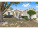 Charming single story home with manicured lawn and front door with decorative glass panes at 9693 Sw 90Th St, Ocala, FL 34481