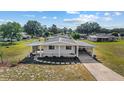 Inviting single-story home with covered parking, complemented by landscaped beds and a well-maintained lawn at 10197 Sw 88Th Ter, Ocala, FL 34481