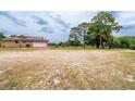 Spacious backyard featuring a garage and providing ample space for outdoor activities at 10631 W Highway 40, Ocala, FL 34482