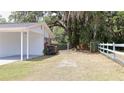 View of the backyard with white fenced property line at 1335 Ne 10Th St, Ocala, FL 34470