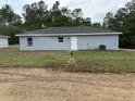 View of backyard with new construction home featuring recently installed lawn and sprinkler at 14437 Sw 21St Pl, Ocala, FL 34481
