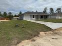 Well-maintained single-story home with a concrete driveway and freshly planted grass at 14437 Sw 21St Pl, Ocala, FL 34481