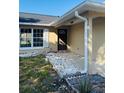Close up of front door entry with rock landscaping and a freshly painted exterior at 3 Pine Radial Ln, Ocala, FL 34472