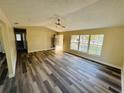 Bright and spacious living room featuring laminate wood flooring and ample natural light at 3 Pine Radial Ln, Ocala, FL 34472