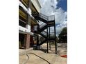External metal stairs are being installed to the side of the multi-Gathering building at 415 Se 1St Ave # 101-B, Ocala, FL 34471