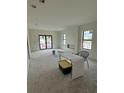 Bright, unfinished living room with black frame sliding glass doors and window at 415 Se 1St Ave # 101-B, Ocala, FL 34471