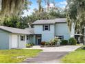 Beautiful two-story home with a lush green lawn and mature trees, offering a serene and private setting at 4237 Chambers St, Lake Wales, FL 33898