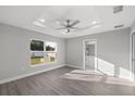 Light-filled bedroom with tray ceiling, recessed lights, ceiling fan, and a view of the yard at 53 Hemlock Trail, Ocala, FL 34472