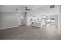 Bright, open-concept living room and kitchen features stainless steel appliances and sleek, modern finishes at 53 Hemlock Trail, Ocala, FL 34472