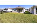 A large backyard features lush lawn and metal fence at 5430 Nw 46Th Lane Rd, Ocala, FL 34482