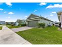 A well-maintained single Gathering home featuring a two-car garage, and a brick-paved driveway at 5616 Nw 39Th Ln, Ocala, FL 34482