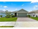 Charming one-story home featuring a two-car garage, brick-paved driveway, and beautifully landscaped front yard at 5616 Nw 39Th Ln, Ocala, FL 34482