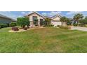 Well-maintained front lawn showcasing manicured landscaping and mature trees at 7455 Sw 97Th Terrace Rd, Ocala, FL 34481