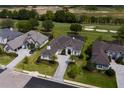 Expansive aerial view of the home next to a golf course, showcasing lush landscaping and a circular driveway at 7585 Nw 33Rd Pl, Ocala, FL 34482