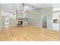 Open living room with vaulted ceiling, wood flooring, and a unique fireplace, ideal for entertaining at 8 Banyan Dr, Ocala, FL 34472