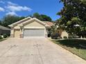 Charming home showcasing a well-manicured lawn and an expansive driveway adorned with unique star decorations at 9019 Se 120Th Loop, Summerfield, FL 34491