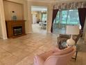 Spacious living area with a fireplace, tiled floors, and sliding glass doors to a patio at 9019 Se 120Th Loop, Summerfield, FL 34491