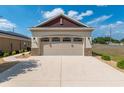 Attached two car garage with a large driveway at 9923 Sw 98Th Ln, Ocala, FL 34481