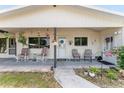 Inviting front porch with rocking chairs and decorative accents creating a cozy entrance at 9940 Sw 103Rd Pl, Ocala, FL 34481